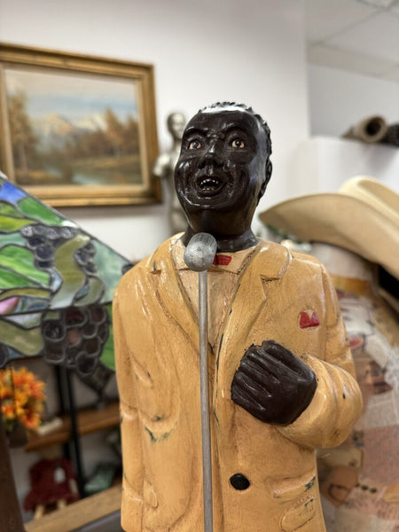 Vintage carved wood jazz singer, maybe Louis Armstrong.