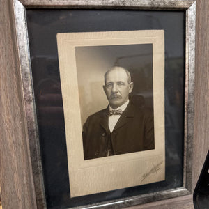 Late 19th century portrait of mustached man on bow tie in wood and silver gilt frame.