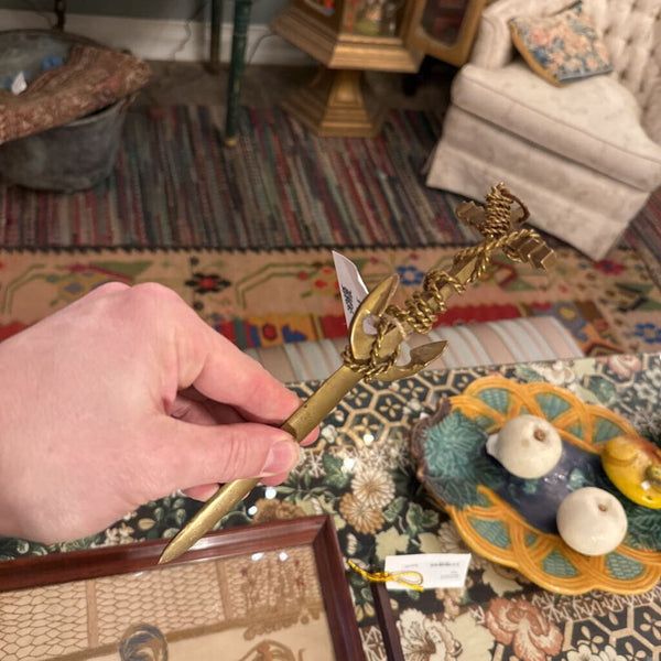 Mid-century brass letter opener with anchor and rope motif. A symbol of steadiness and the sea-crafted with sculptural detail and maritime charm.