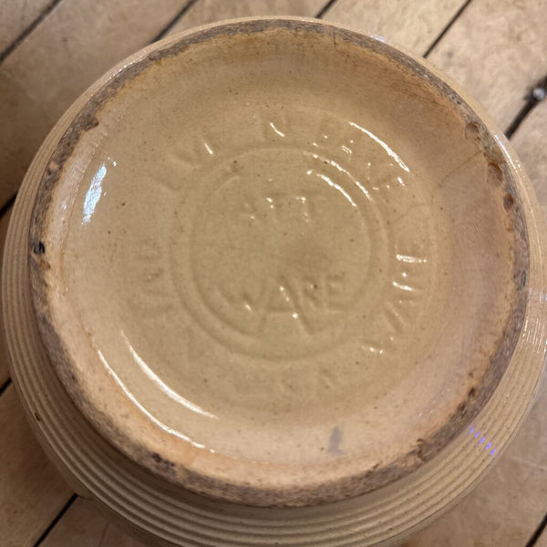 Yellow Watt ware eve-n-ware bowl with stripes. 5" H 8" Diameter at top of bowl