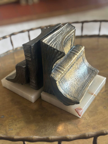 PAIR OF “BOOKISH” BOOKENDS ON MARBLE BASES. EACH BOOKEND IS 6"H x 5"W x 4"H