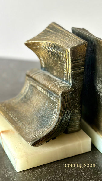 PAIR OF “BOOKISH” BOOKENDS ON MARBLE BASES. EACH BOOKEND IS 6"H x 5"W x 4"H